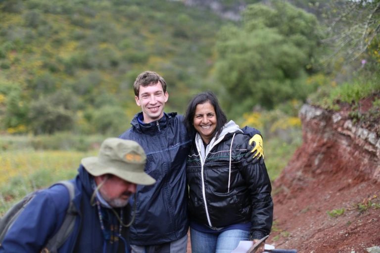 3 team members smiling on the dig slope