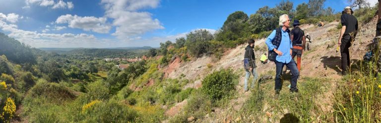 Team members on a hillside overlooking the Algarve countryside