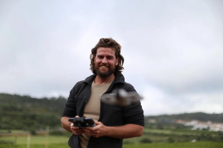 Expedition member holding a camera in the field