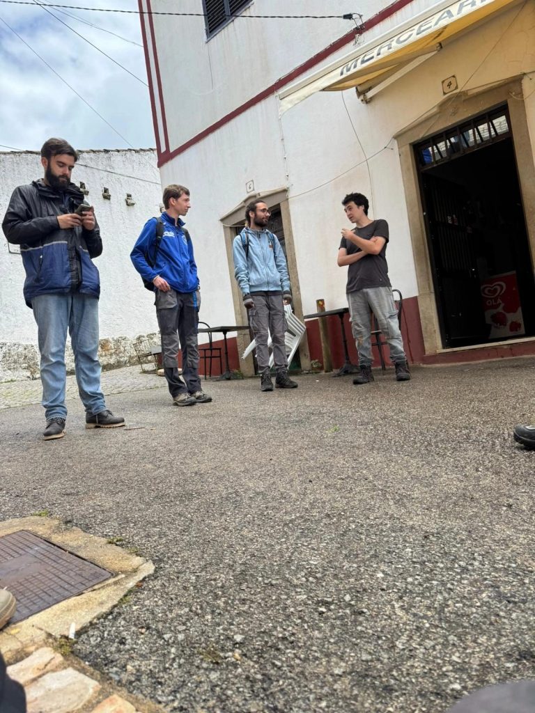 Team members gathered outside a village building