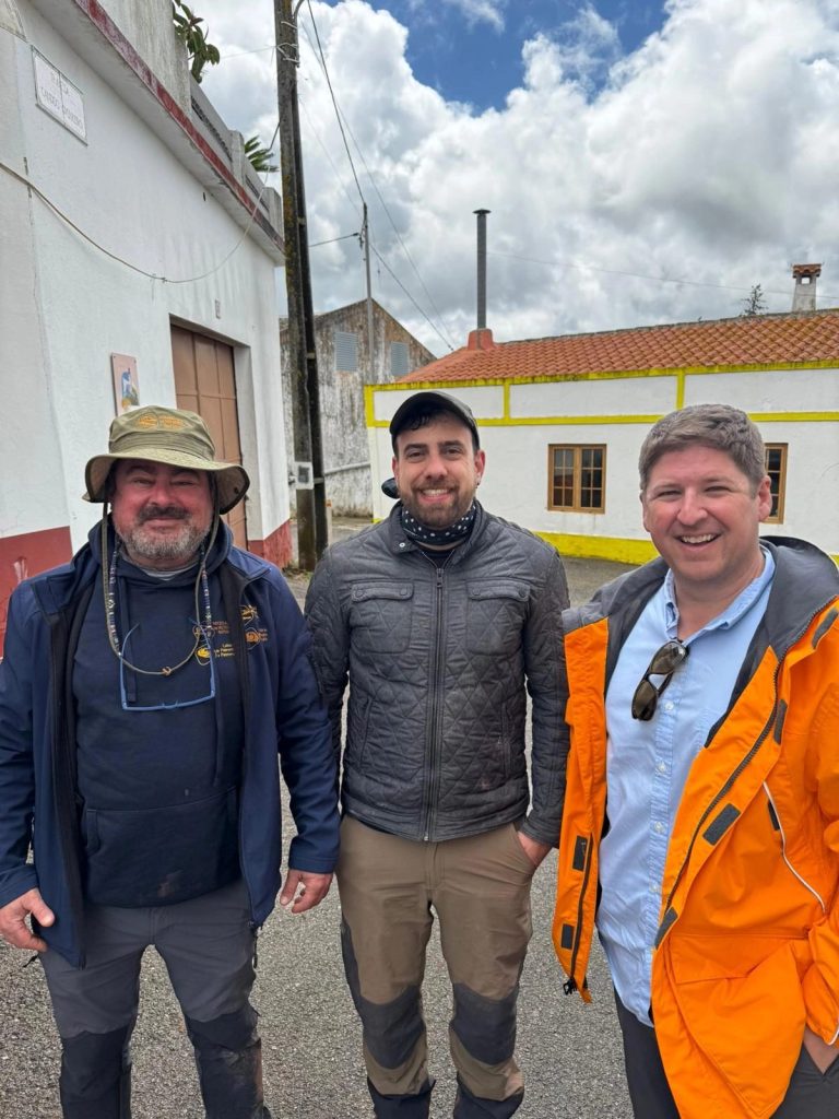3 expedition members in a village street