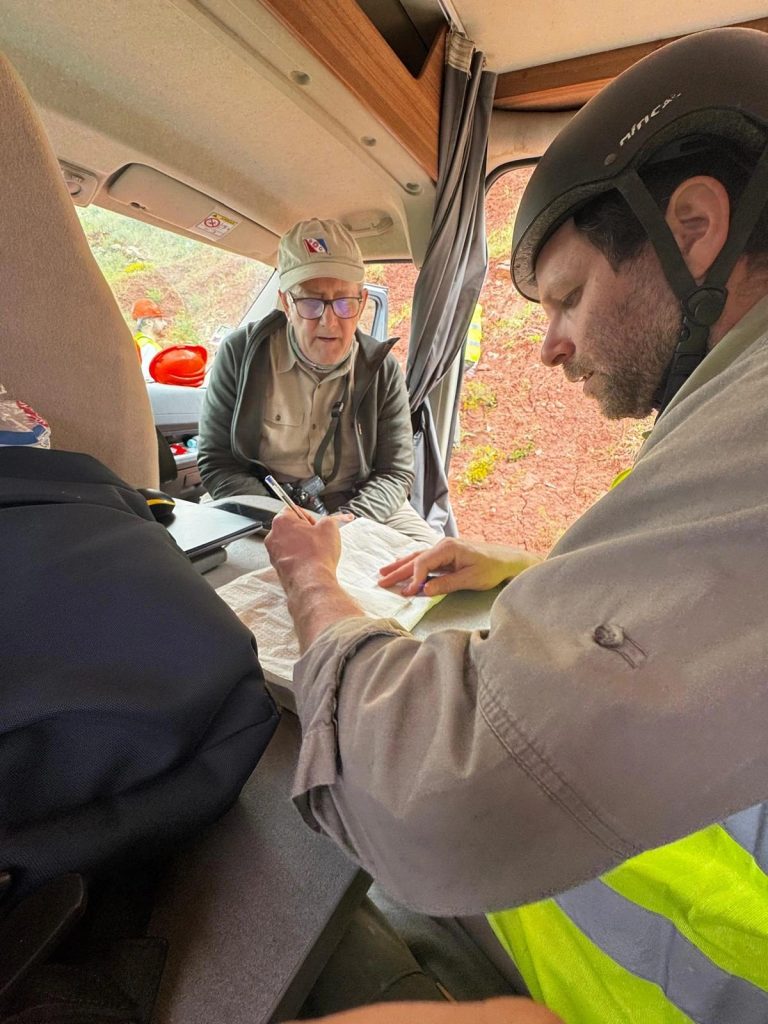 Team members reviewing notes inside the van